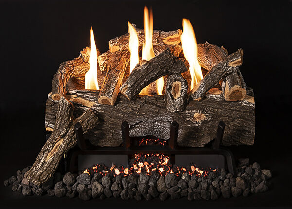 A weathered Ventless gas log set with tall, yellow flames, lava rock, and glowing embers on a black fireplace grate.