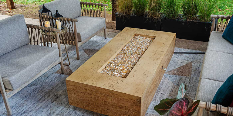 The Tuscan Gas Fire Pit by FlameCraft with reflective bronze-colored fire pit glass media