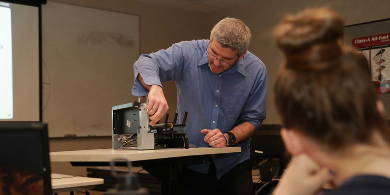 An NFI Certified Master Hearth Professional teaching a class for Woodland Direct's sales team