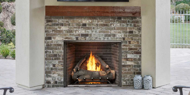The traditional Courtyard gas fireplace from Majestic features a large, square design with multiple masonry-style firebox liners and two realistic log sets.