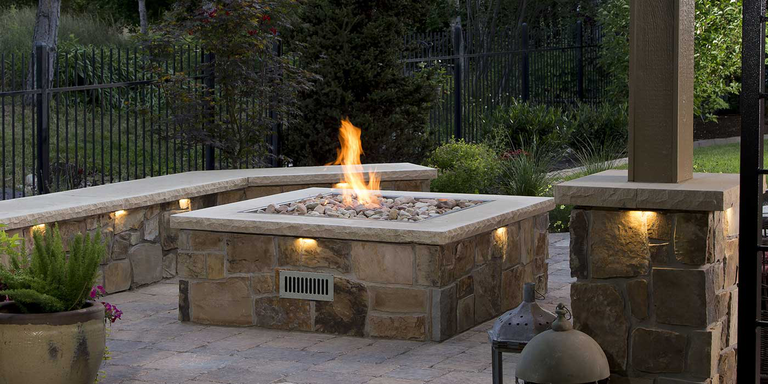 A gas fire pit made of stone blocks