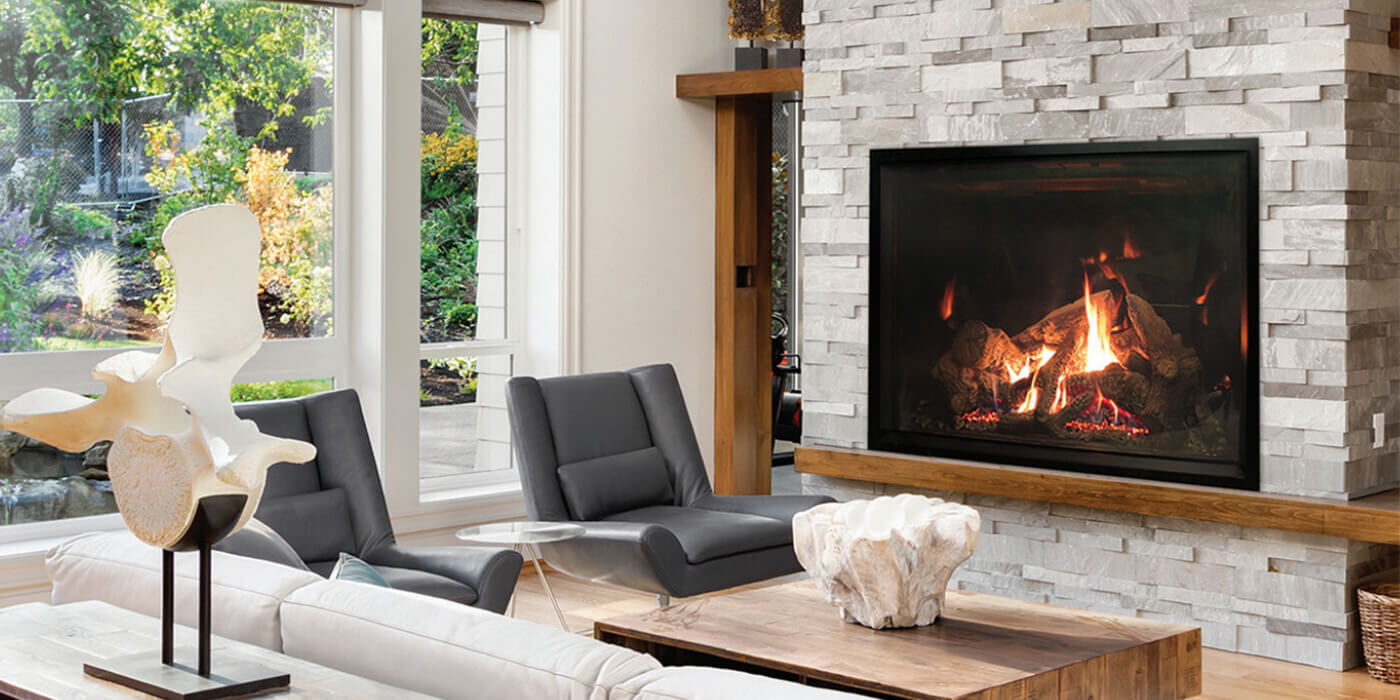 An extra-large, square gas fireplace installed in a simple, contemporary living room with minimal accents and a natural stone hearth