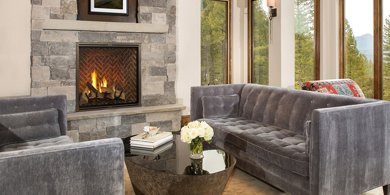 A traditional living room with an extra-large gas fireplace and realistic log set