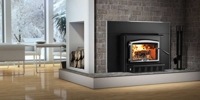 A modern dining area and living room with a classic Osburn high-efficiency wood burning stove insert.