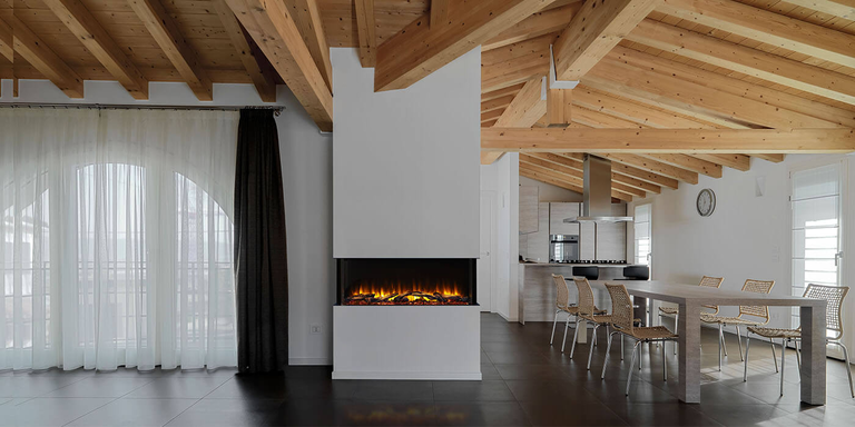 A linear multi-sided electric fireplace installed in an open-concept home between the living room and dining area