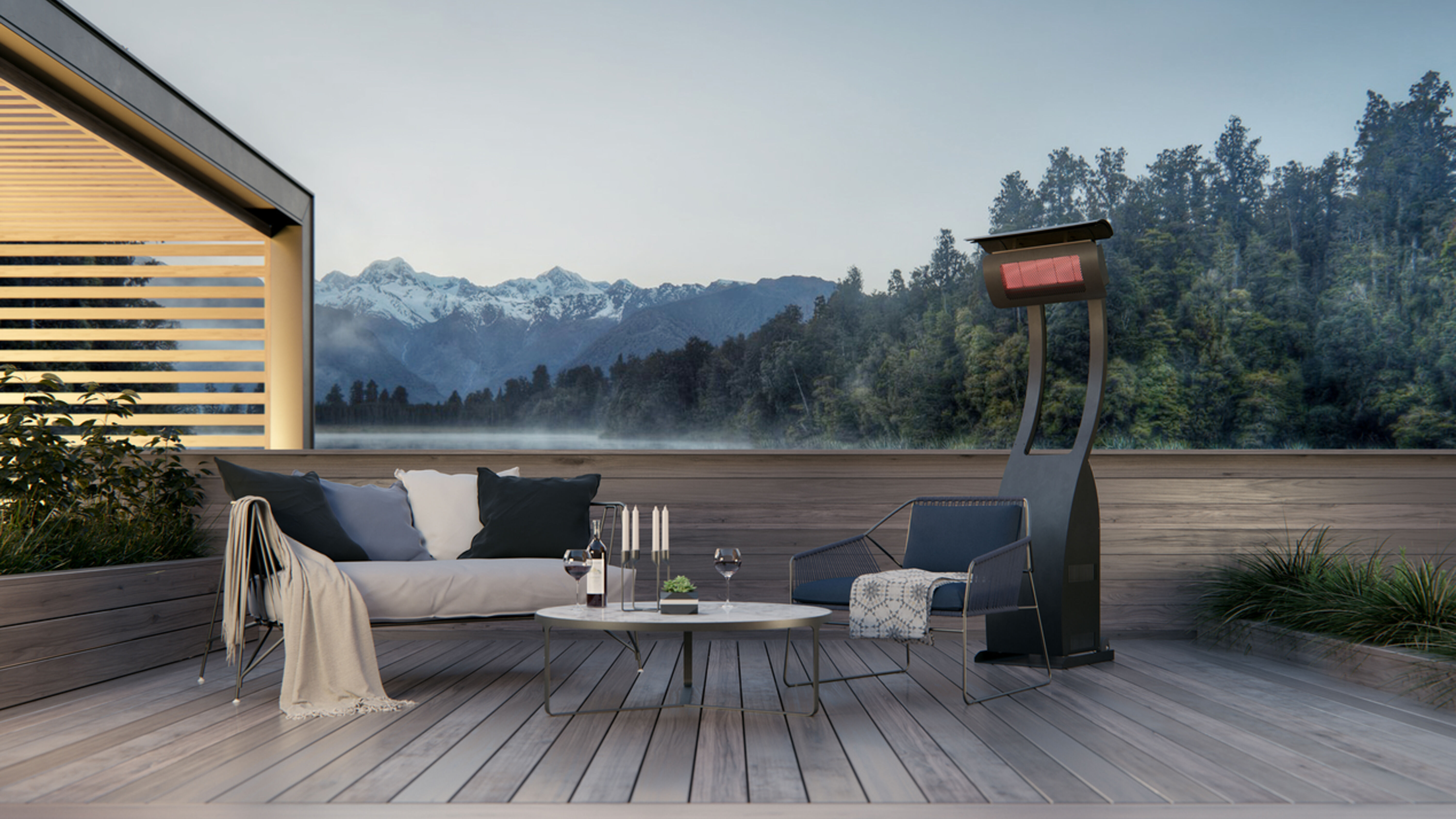 An outdoor deck located in the mountains with a grey outdoor couch, a small black table, and a portable gas patio heater nearby.