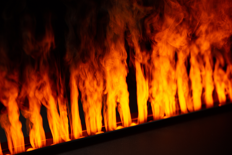 A close-up view of the Dimplex Opti-Myst electric fireplace's vibrant, realistic orange flames.