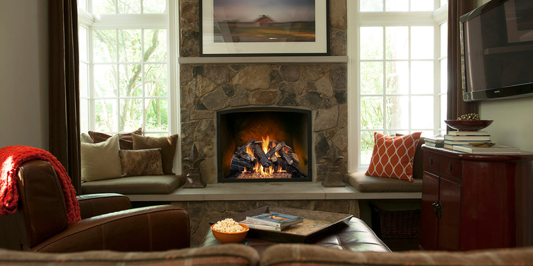A traditional living room with a fireplace and Vented gas log set from Real Fyre