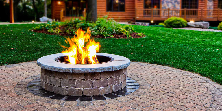 The Necessories steel fire ring insert comes with a built-in cooking grate, so you can grill meals over the fire while you host your friends and family.