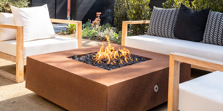 A square Corten Steel gas fire pit from the brand The Outdoor Plus