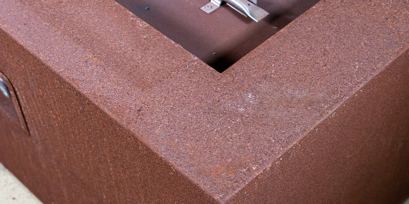 Close-up of a Corten steel gas fire pit Close-up of a Corten steel gas fire pit