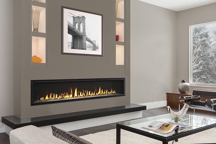 A modern indoor living room with a large, linear gas fireplace 