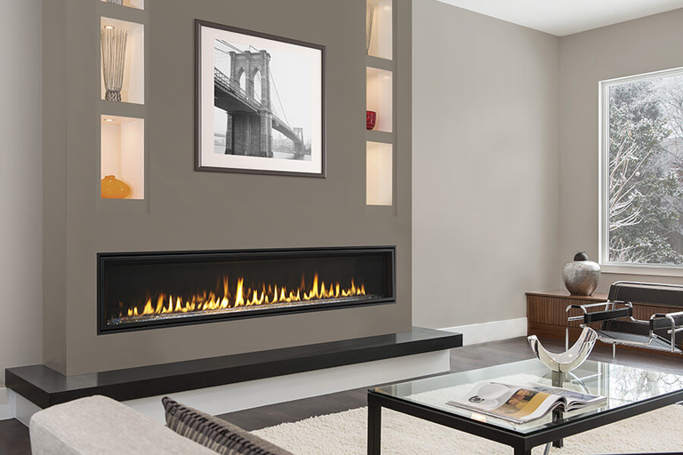 A modern indoor living room with a large, linear gas fireplace 