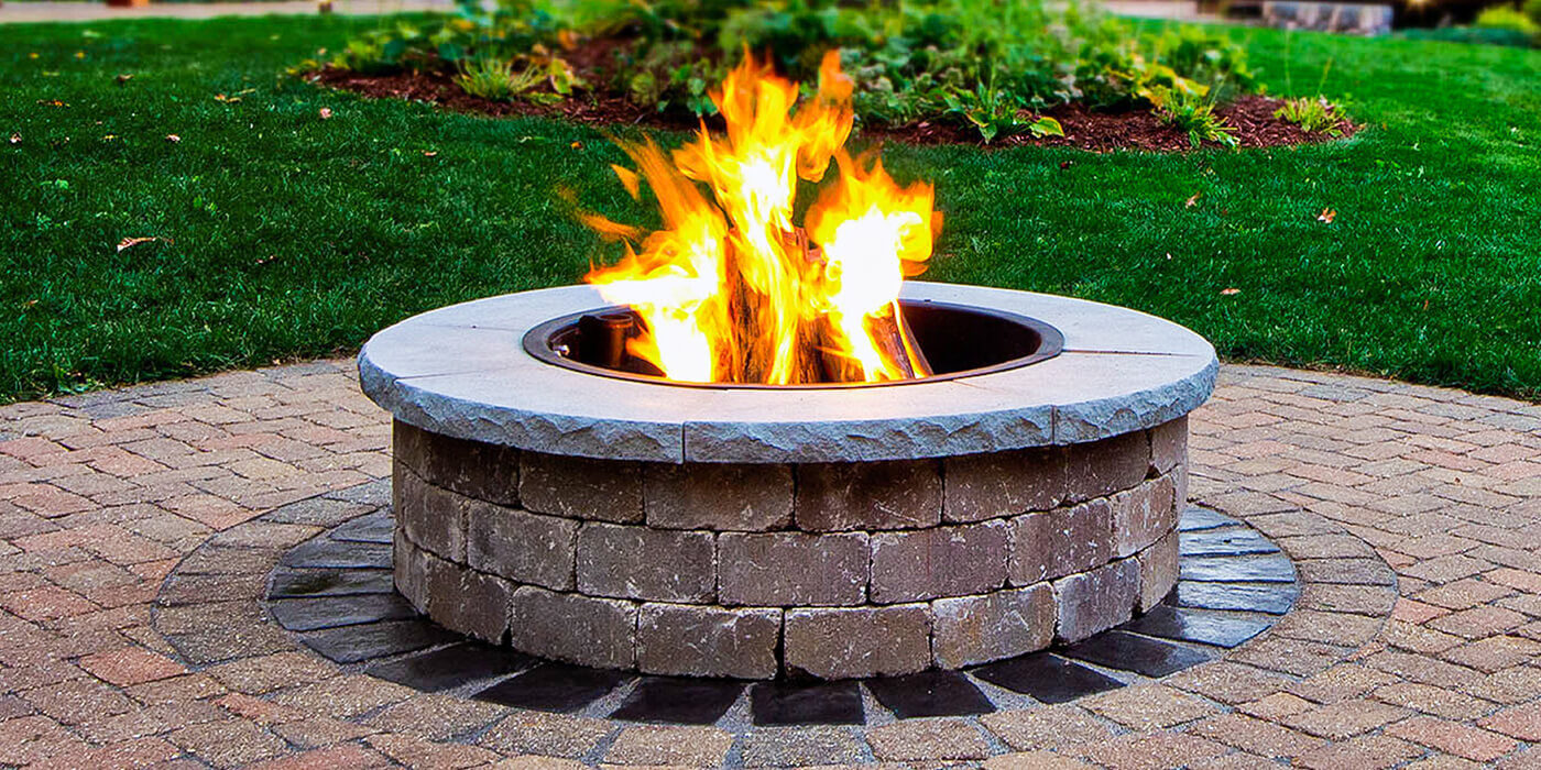 A custom-built large stone wood burning fire pit