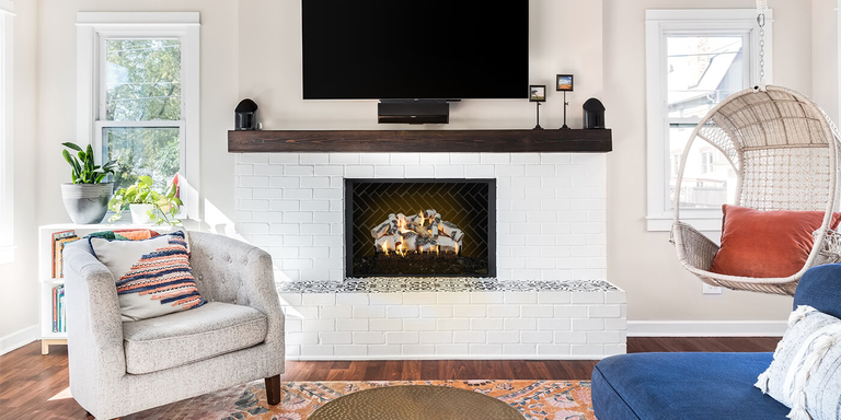 A modern, white brick hearth with a square fireplace and a realistic, Birch-style gas log set from Grand Canyon Gas Logs