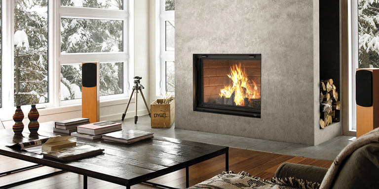 A contemporary living room with a large, square wood burning fireplace