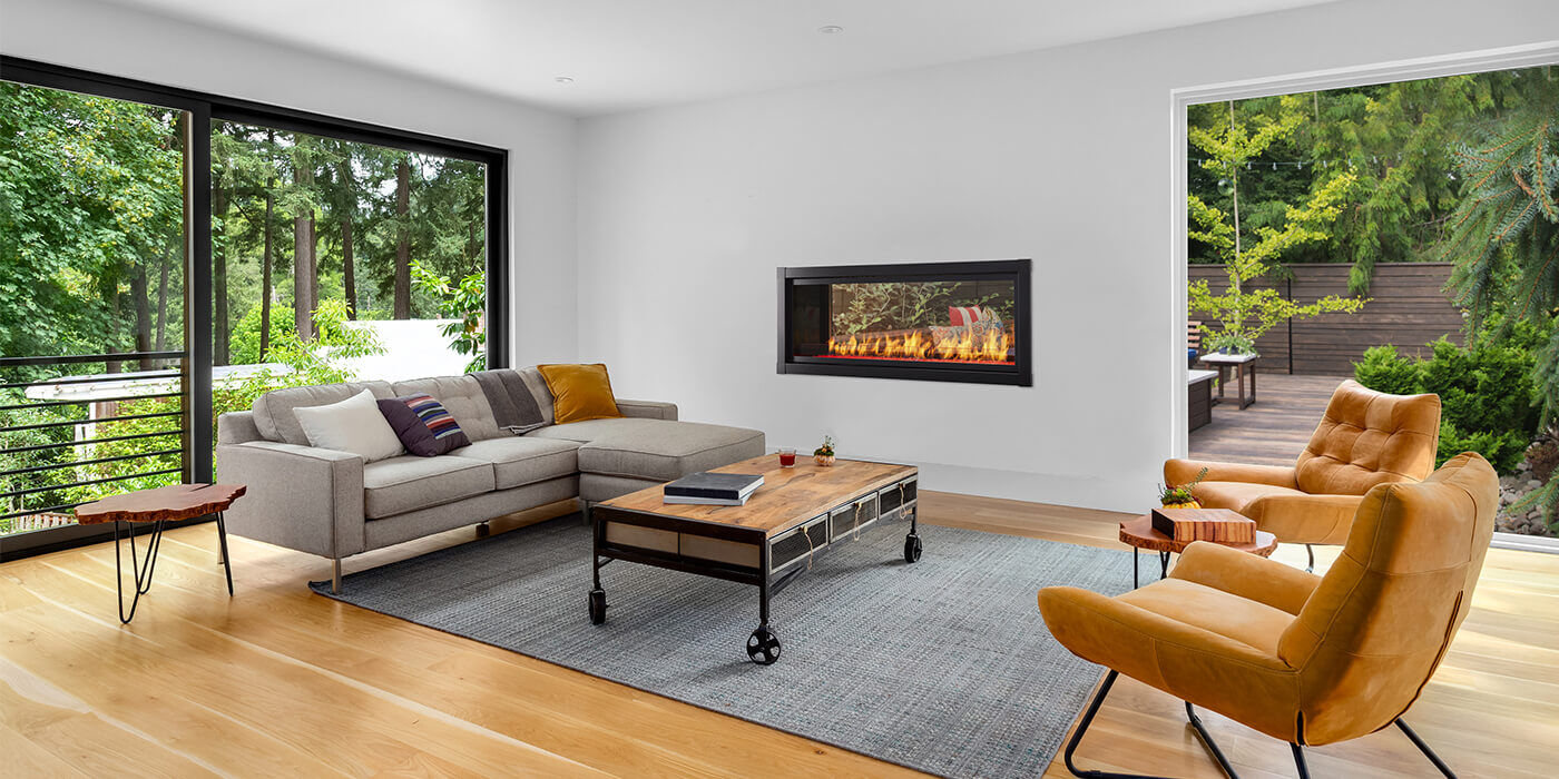 A linear see-through gas fireplace that is visible from both inside and outside the house