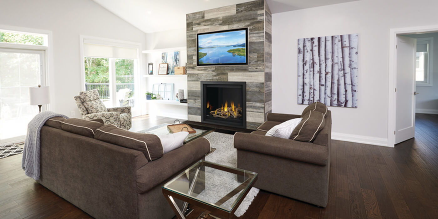 An indoor living space with a traditional, square shaped Direct Vent gas fireplace and log set 