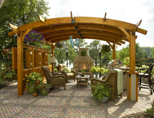 Day view of backyard patio with gas fireplace and pergola