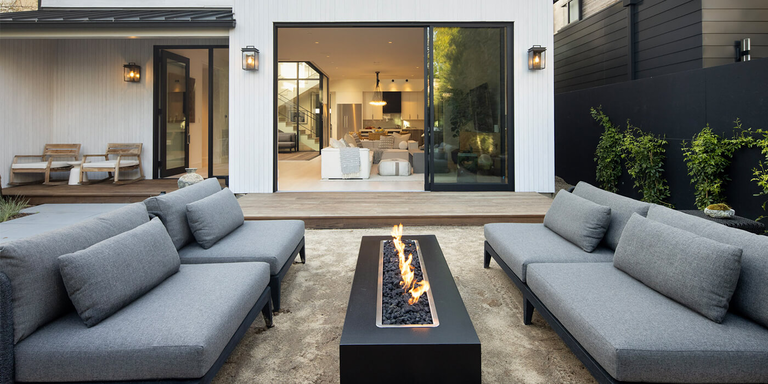 A contemporary outdoor living space with a modern linear gas fire pit
