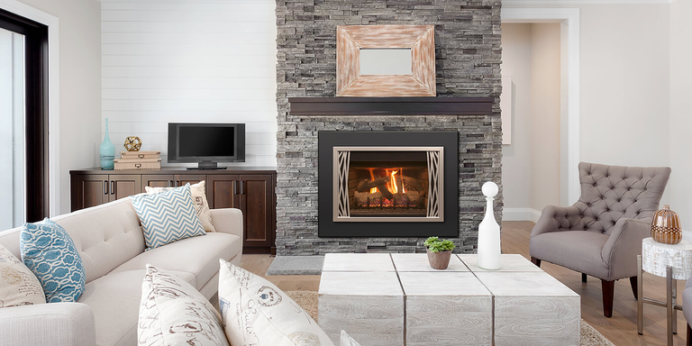 A contemporary living room with a classic square fireplace and a realistic Vented gas log set
