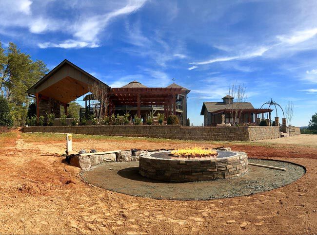 Unfinished fire pit in front of a covered patio