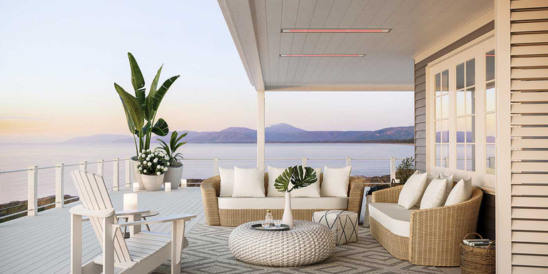 An ocean-side outdoor living space with Bromic Platinum Marine Grade patio heaters recessed into the ceiling and a seating area underneath