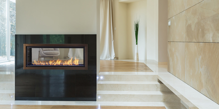 A modern linear gas fireplace in an open concept house