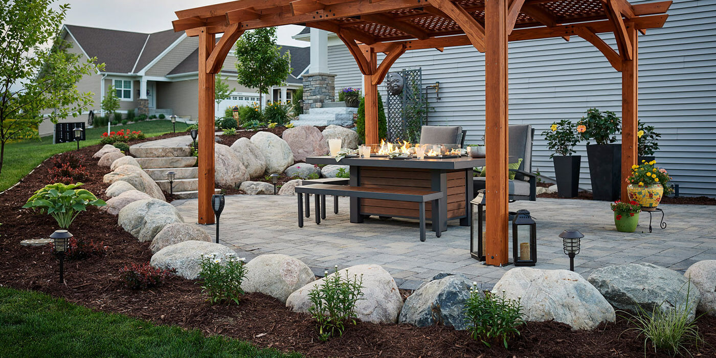 An outdoor gas fire pit table under a gazebo 