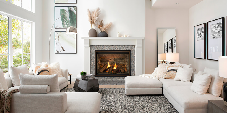A contemporary living room with a large square gas fireplace and a white mantel