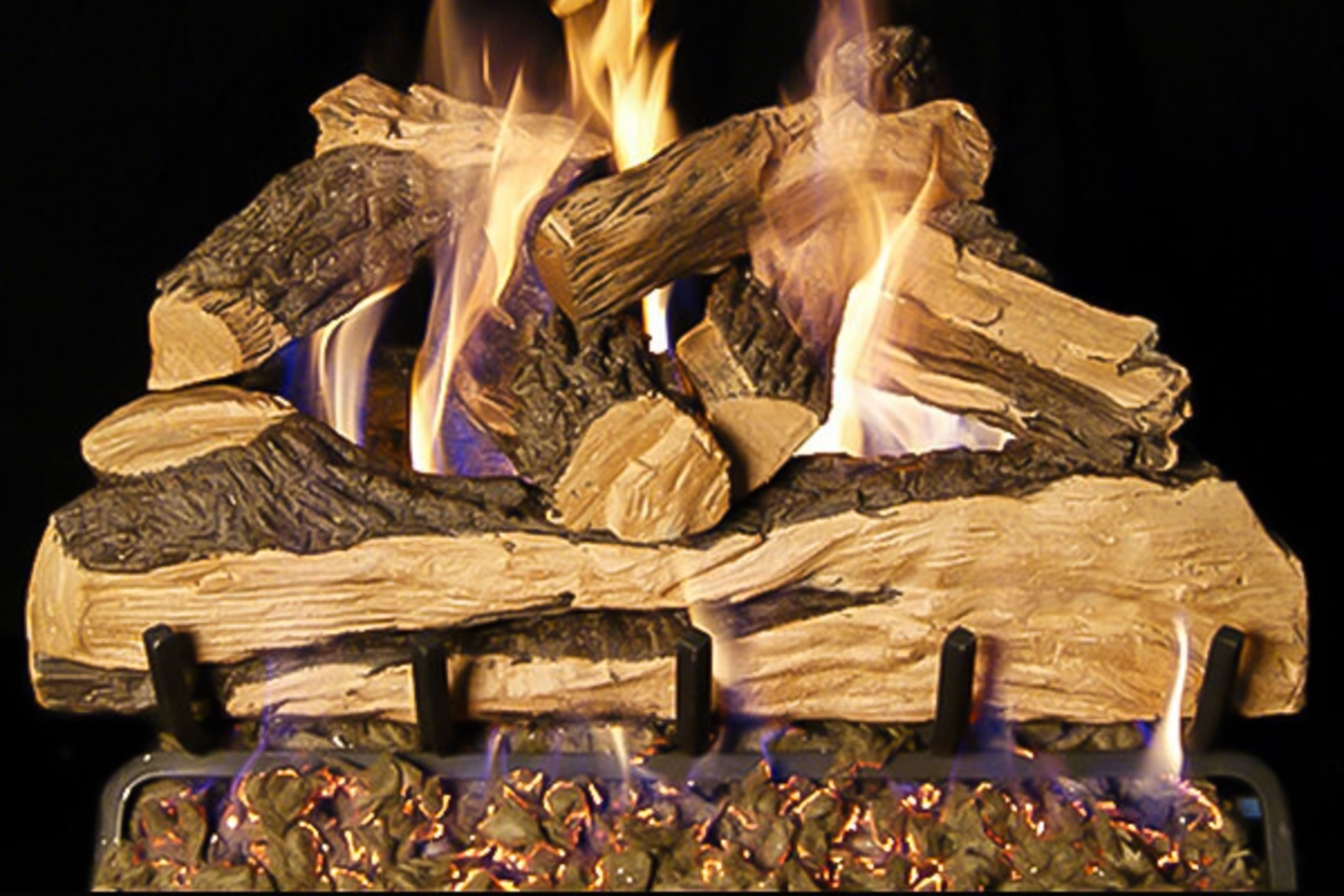 A stack of Vented Oak-style gas logs with natural splitting on a black background. 