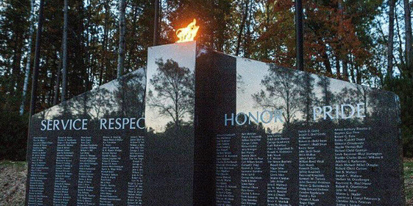 Close-up of the eternal burning flame in a gray granite veteran memorial