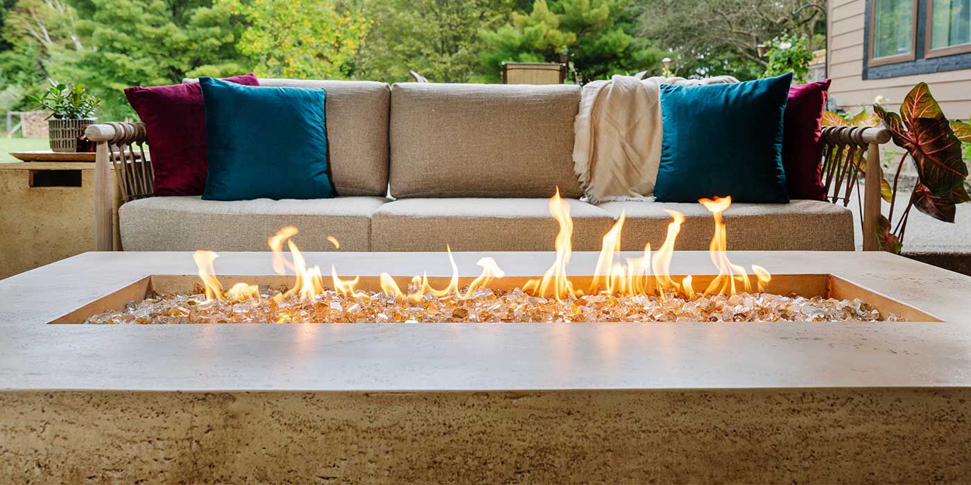 The Tuscan Gas Fire Pit by FlameCraft in an outdoor living space