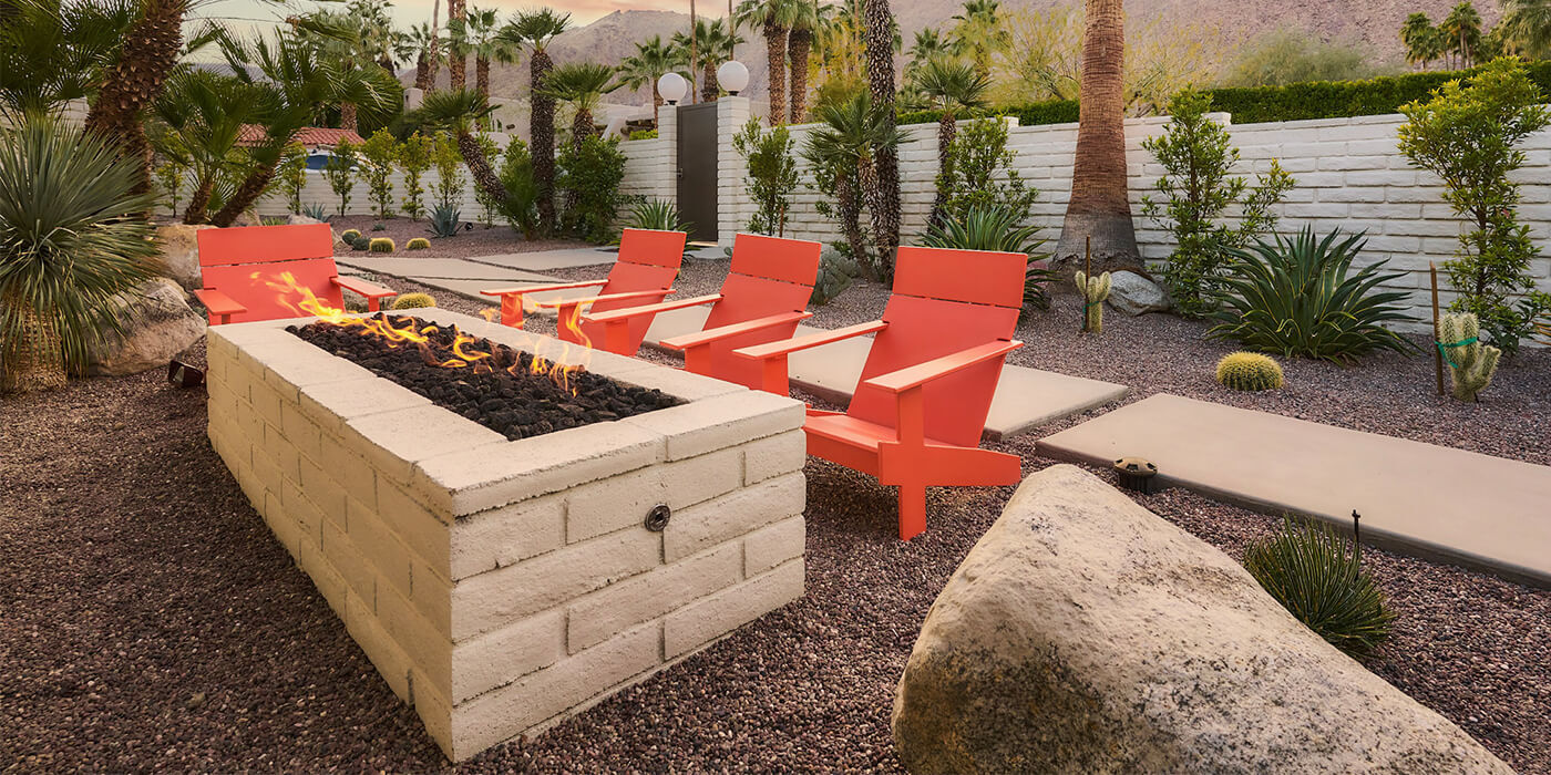 An outdoor space with a custom fire pit area and seating  An outdoor space with a custom fire pit area and seating