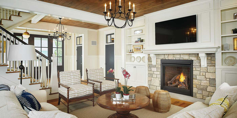 A traditional living room with a classic, square gas fireplace and rustic gas log set