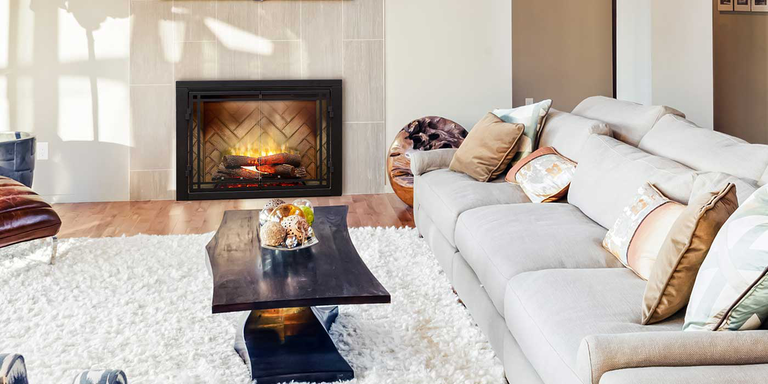 A living room with a realistic, traditional-looking electric fireplace 