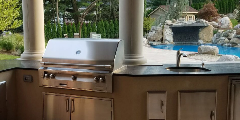 A curved ready to finish outdoor kitchen island 