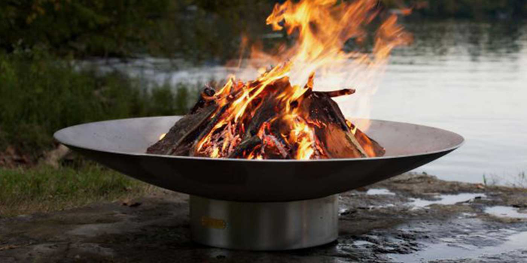 A stainless steel Bella gas fire pit by Fire Pit Art