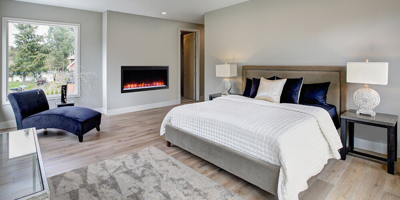 A linear electric fireplace installed in a large bedroom 