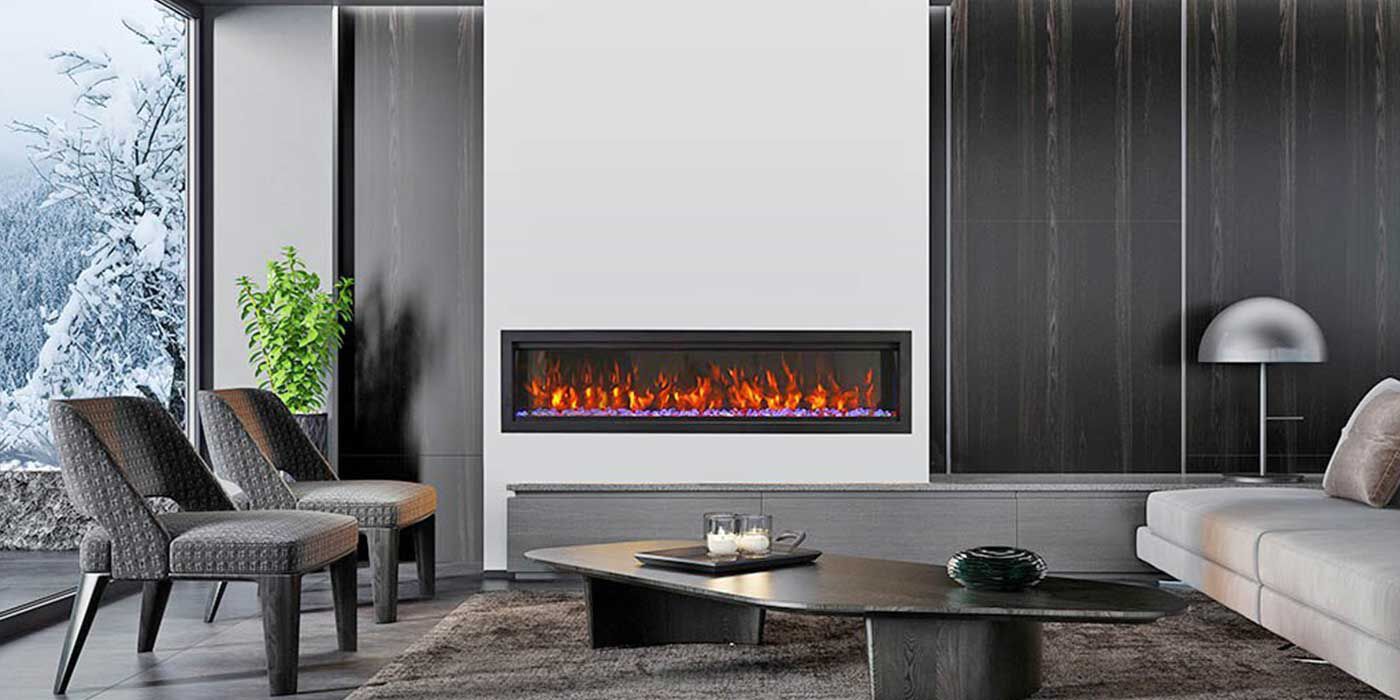 A modern living room with a floor-to-ceiling window, two grey accent chairs, a low, long black coffee table, a low white couch, and a large, linear gas fireplace.
