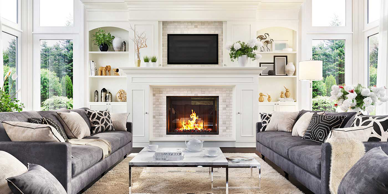 A large living room with a traditional, square gas fireplace