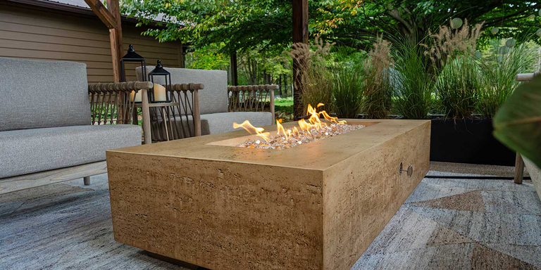 The FlameCraft Tuscan Gas Fire Pit installed under a covered patio space