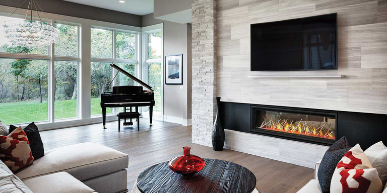 A modern living space with a linear Napoleon gas fireplace, a flatscreen TV above the fireplace, and a grand piano in a background