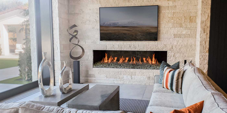 An modern living room with a Maximus Linear Isokern masonry fireplace, finished with beige bricks