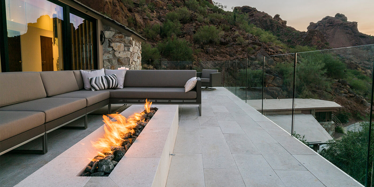 A modern outdoor patio with a custom linear gas fire pit