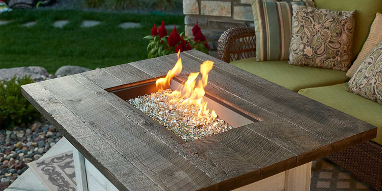 A fire pit table with clear fire pit glass media