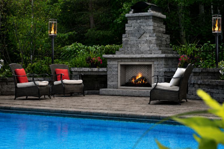 Outdoor fireplace with flame blowing in the wind.