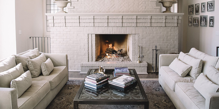 A transitional indoor living room with a custom-built wood burning fireplace