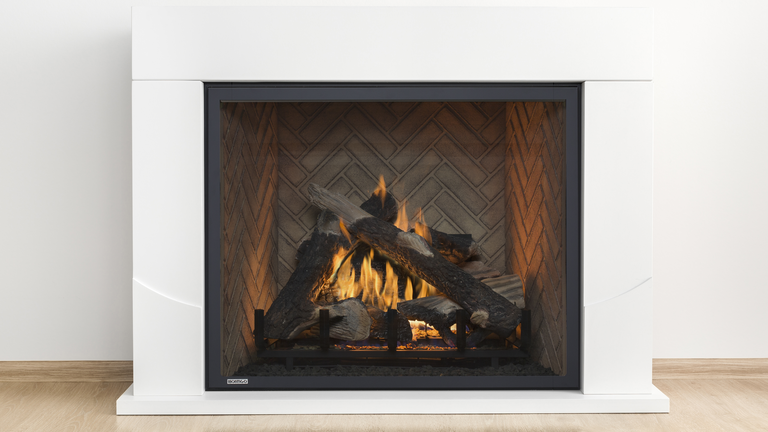 A clean, white hearth with a square, traditional-looking gas fireplace and a realistic gas log set.