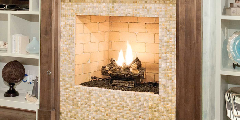 A Standard Isokern fireplace with a brick firebox and a multi-colored beige tile exterior finish.